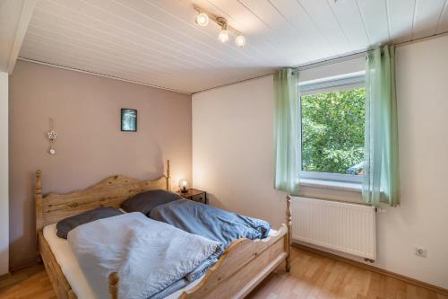 a bedroom with a bed and a window at Ferienwohnung Waldblick in Freudenstadt