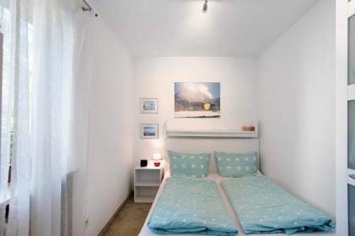 a bedroom with a bed and a painting on the wall at Ferienwohnung Wölk in Sonthofen
