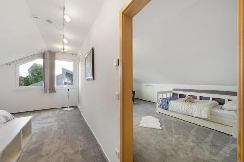 a bedroom with a bed and a window at Ferienwohnung Nordschwarzwald in Altensteig