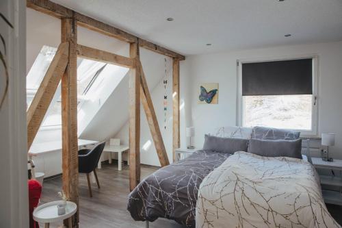 a bedroom with a bed and a desk and a window at Ferienwohnung Wunderbar in Bad Wildbad