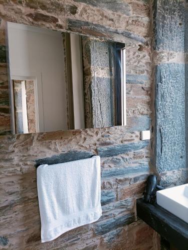 a bathroom with a mirror and a towel at Valley Apartamentos T1 in Vila Nova de Foz Coa