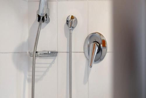 a shower head and a shower wand on a wall at Ferienwohnung Zugspitze in Grainau