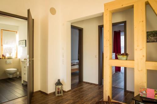 a hallway with a bathroom and a toilet in a room at Ferienwohnung Lindenhof in Dormettingen