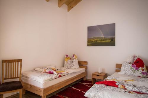 two beds in a room with a rainbow on the wall at Ferienwohnung Lindenhof in Dormettingen