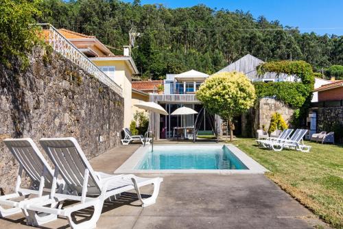 a villa with a swimming pool and a house at Casa Da Vovó São in Vila Nova de Cerveira