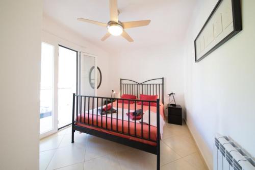 a bedroom with a bed and a ceiling fan at Mestral in Port de Soller