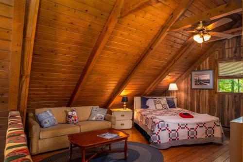 a bedroom with a bed and a couch in a cabin at Chestnut Ridge in Connestee · Chestnut Ridge in Connestee Falls in Rosman