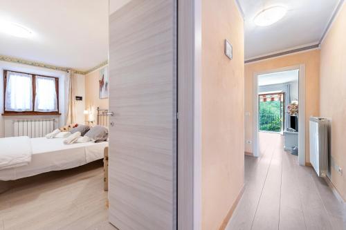 a bedroom with a bed and a sliding door at Residence Tatiana Dependance in Tremosine Sul Garda