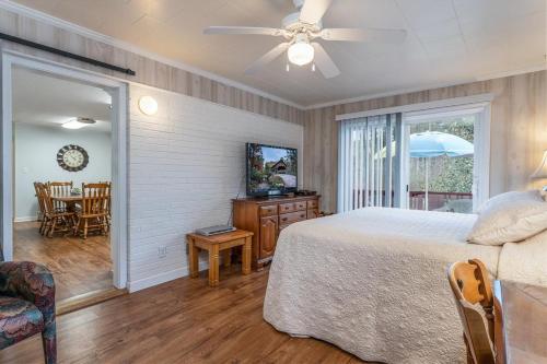 a bedroom with a bed and a table and chairs at Bike Path Getaway in Town · On bike path, NEW KITCHEN,walk to St in Brevard