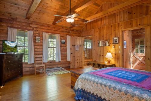 a bedroom with a bed and a ceiling fan at Great Escape Cabin · Great Escape Cabin in Connestee Falls in Brevard