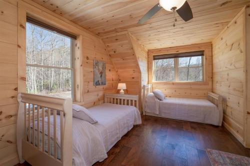 a bedroom with two beds in a log cabin at El Escorpio North · El Escorpio North - New Rental in Brevard