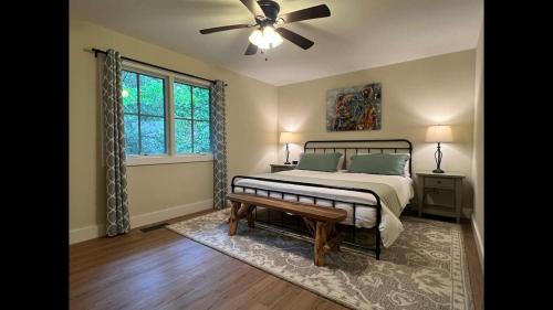 a bedroom with a bed and a ceiling fan at Shady Creek Cabin · Shady Creek Cabin in Connestee Falls with s in Brevard
