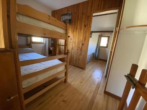 a bedroom with two bunk beds and a mirror at Gîte le Suquet - en pleine nature in Dourbies
