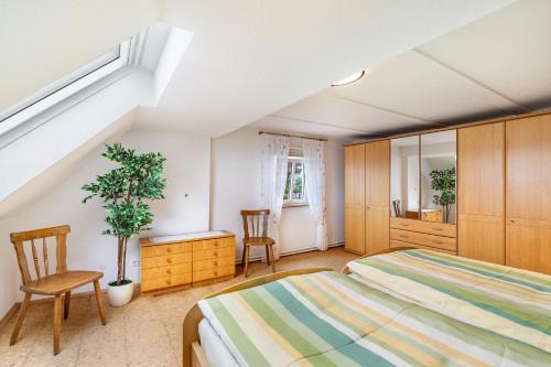 a bedroom with a bed and a table and chairs at Ferienhaus Albert in Bühl