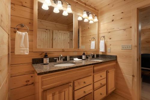 a bathroom with a sink and a mirror at Hideaway Cabin · Hideaway Cabin in Cedar Mountain in Cedar Mountain