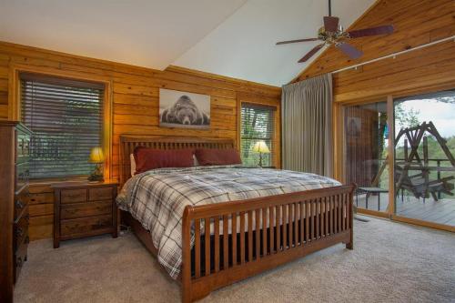 a bedroom with a bed and a wooden wall at Blissful Bears Mountain · Blissful Bear Cabin, Long Range View 2 in Brevard