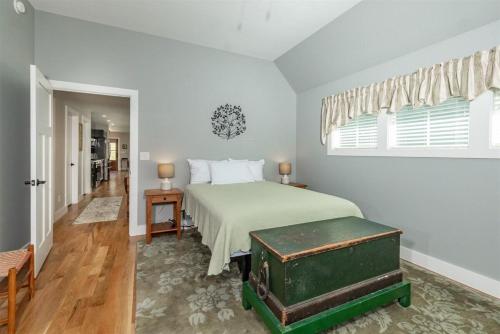 a bedroom with a bed with a green trunk at Rosie`s Retreat · Rosie`s Retreat in Brevard