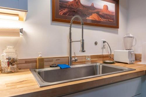a kitchen counter with a sink in a kitchen at The Deep Forest Green Cottage · The Deep Forest Green Cottage in Cedar Mountain