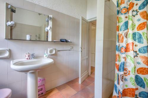 a bathroom with a sink and a shower curtain at Palazzetto Bovini in Perugia