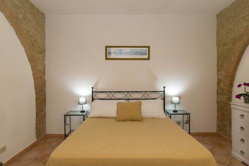 a bedroom with a large bed with two tables at Podere Nuti - 2 Beloro in Cecina