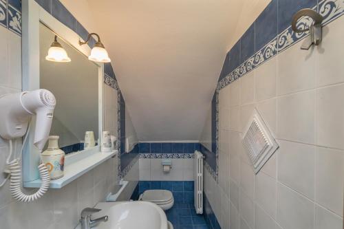 a bathroom with a white toilet and a mirror at Podere Nuti - 2 Beloro in Cecina