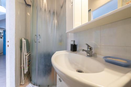 a bathroom with a sink and a shower at Casa San Fruttuoso in Carloforte