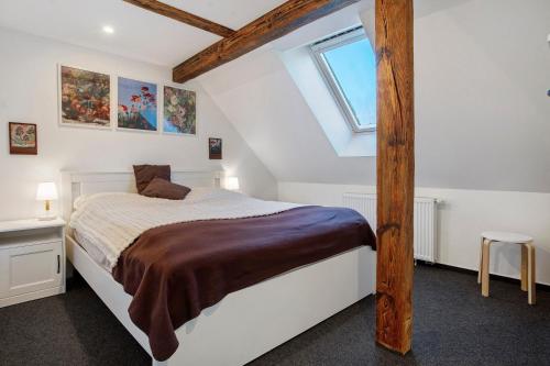 a bedroom with a large bed with a wooden post at gemütliche Ferienwohnung in Seenähe in Neustrelitz