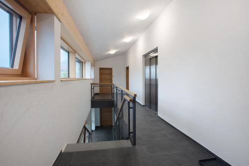 a staircase in a house with white walls and windows at Haus Wiesenquelle in Feldberg