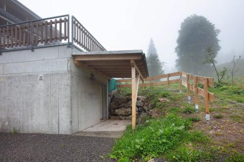 a building with a porch and a wooden ramp at Haus Wiesenquelle in Feldberg