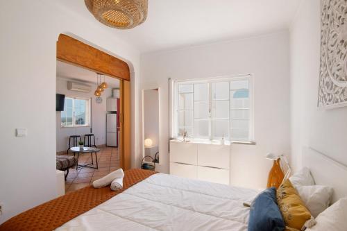 a bedroom with a large bed and a window at A Casa de Emy in Cabanas de Tavira