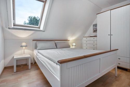 a bedroom with a large bed with a window at Ostsee in Pruchten