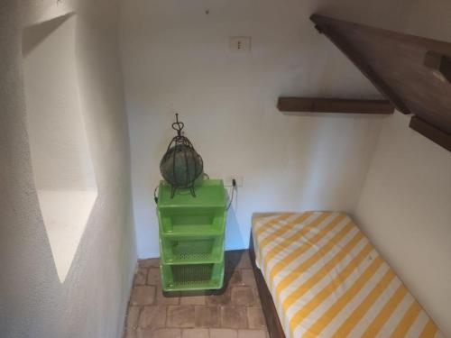 a room with a bed and a hanging basket at Antico Dammuso Al Tramonto in Pantelleria