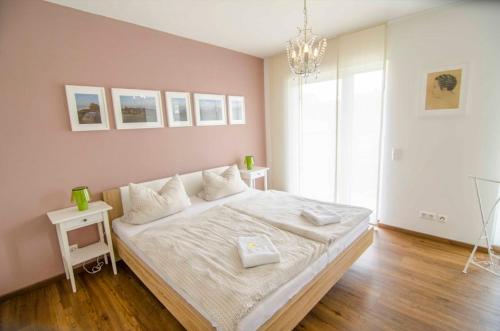 a bedroom with a large bed with white sheets at Bianca's Kaiserstuhl in Ihringen