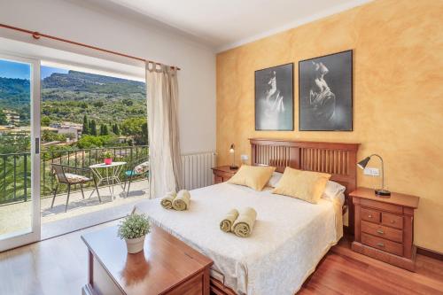 a bedroom with a bed and a large window at Casa Caterina in Port de Soller