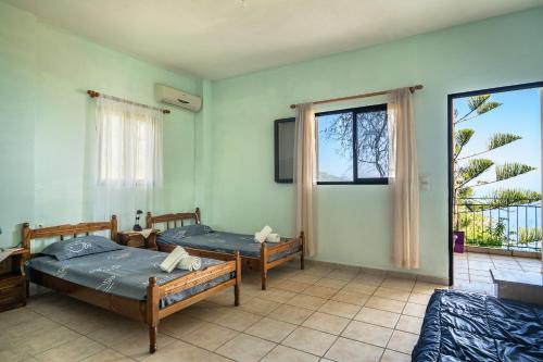 a room with two beds and a window at Vangelis studio 1 in Kefalonia