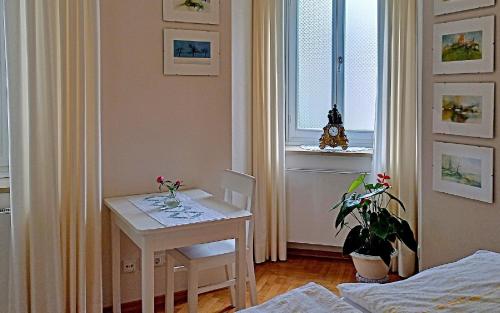 a room with a table and a table and a window at Villa Karlsbach in Teisendorf