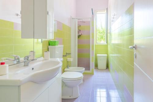 a bathroom with a sink and a toilet and a shower at Casale siculo in Avola