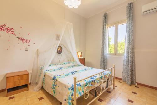 a bedroom with a bed with a canopy at Casale siculo in Avola