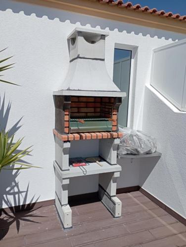 a brick oven sitting on top of a patio at T2 Moliceiros Torreira vista Ria in Torreira