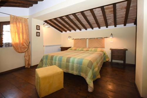 a bedroom with a bed and a wooden floor at La Valle Del Sole - Val D'Orcia in Castiglione dʼOrcia