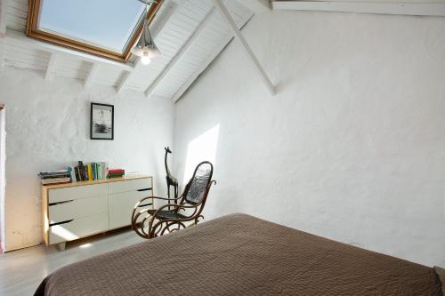 a bedroom with a bed and a chair and a dresser at Casa Cueva Tejeda 2 dorm in Tejeda