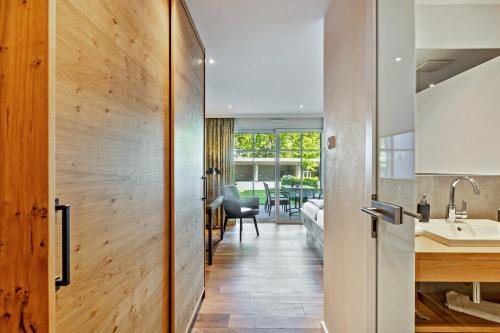 a kitchen and living room with a door leading to a dining room at Doppelzimmer Mit Terrasse in Schmallenberg