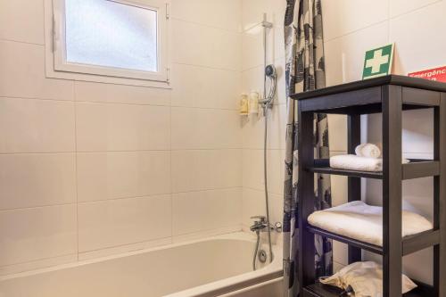 a bathroom with a shower and a bath tub with towels at Casa da Olides - T3 in Santana