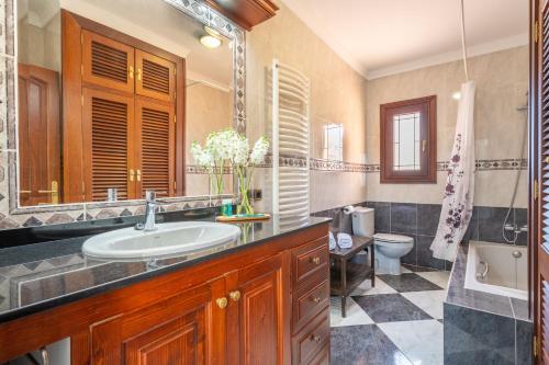 a bathroom with a sink and a toilet at Villa Manrique in Cala Ratjada