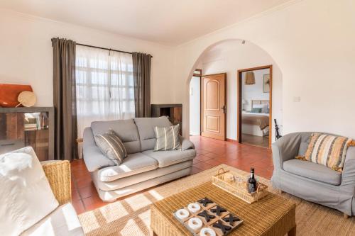a living room with a couch and a table at Casa da Olides - T3 in Santana