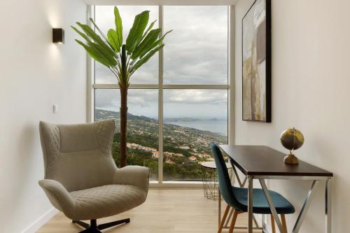 a room with a chair and a table and a window at Casa Belavista in Gaula