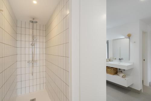 a white bathroom with a sink and a mirror at Yucas Villa 17 in San Bartolomé