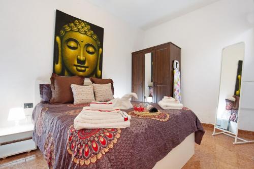 a bedroom with a bed with a large yellow mask on it at Casa Alexis in Lajita