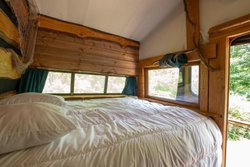 a bedroom with a bed and a window at la pêcherie in Malbosc