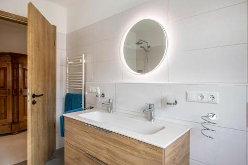 a bathroom with a sink and a mirror at Ferienwohnung Maria in Gilching